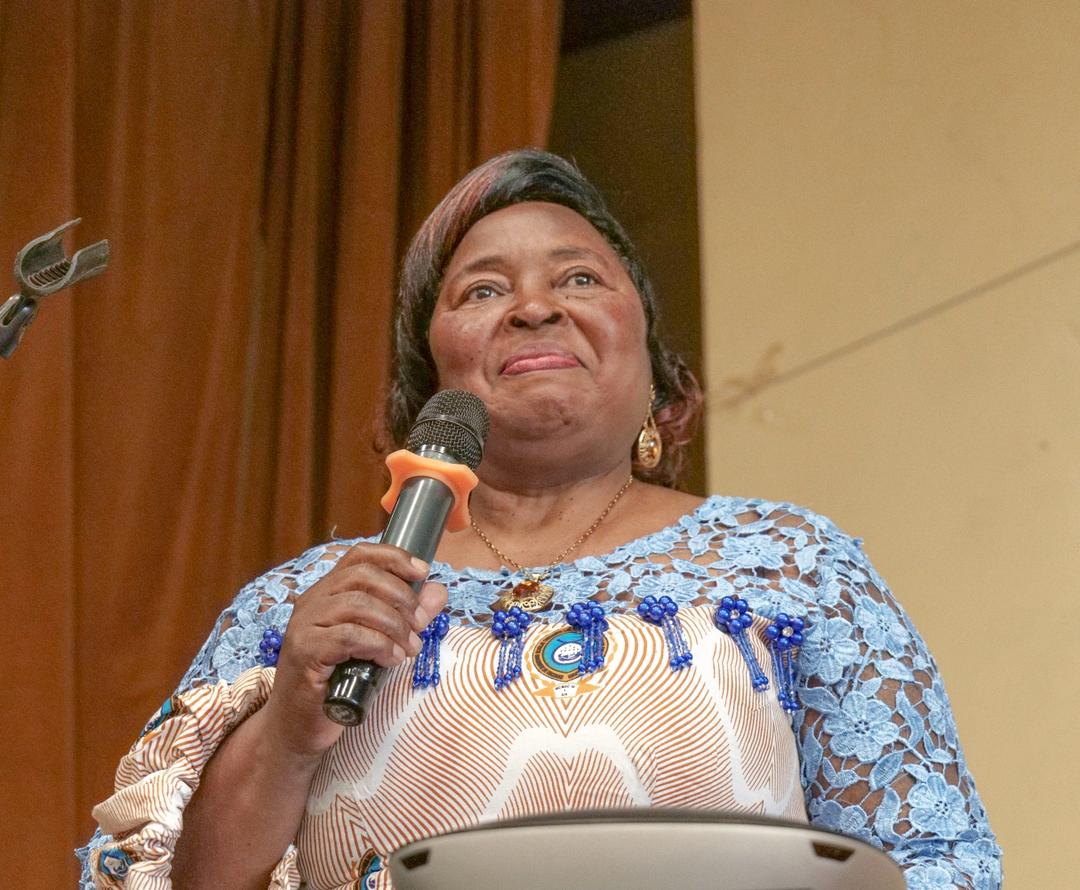A university representative speaking at the AlgoTech conference podium