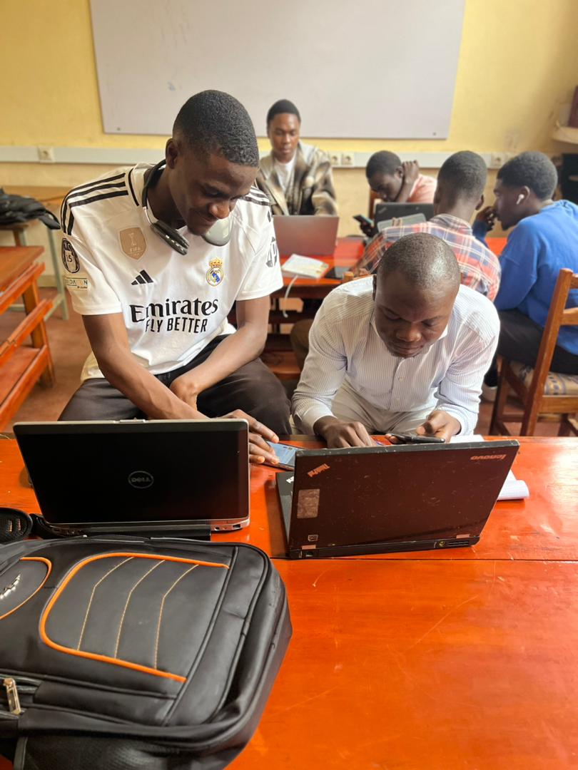 Two students collaborating on laptops during the AlgoTech hackathon