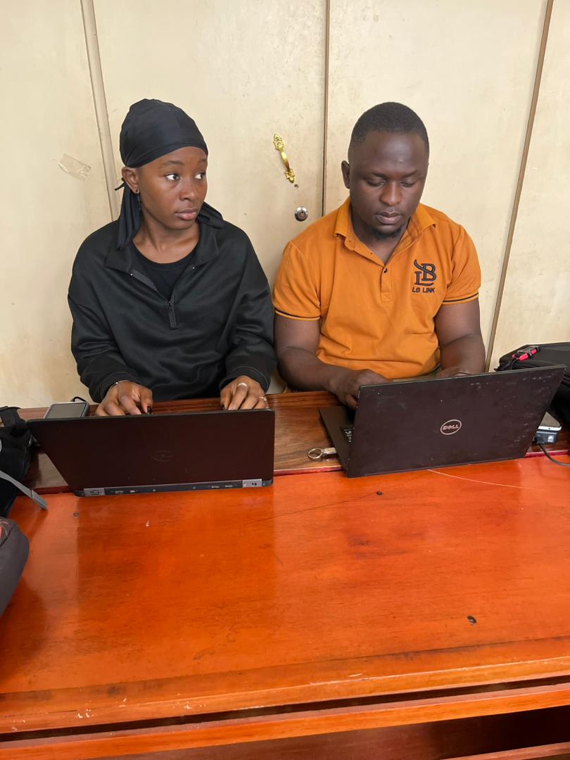 Two participants working side by side on separate laptops during the hackathon