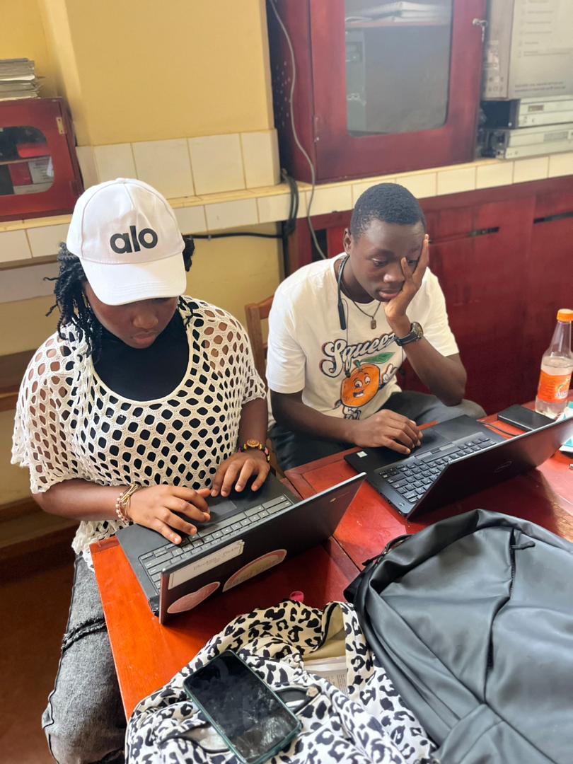 A hackathon team working with laptops and notes during the cybersecurity exercise